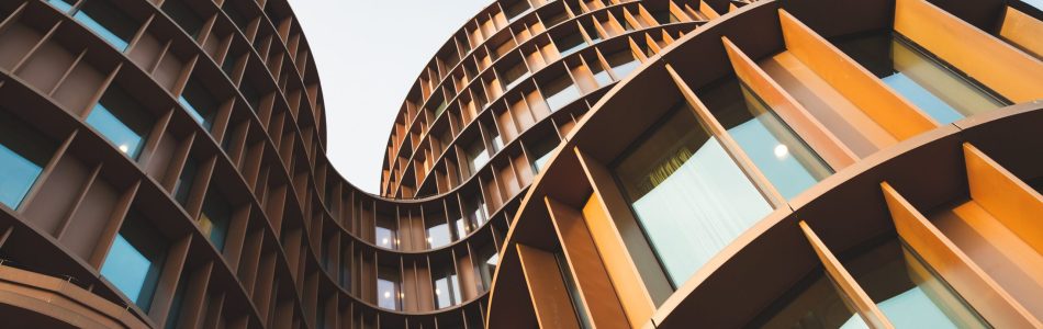 Abstract contemporary architecture background, round towers made of yellow shiny metal and glass